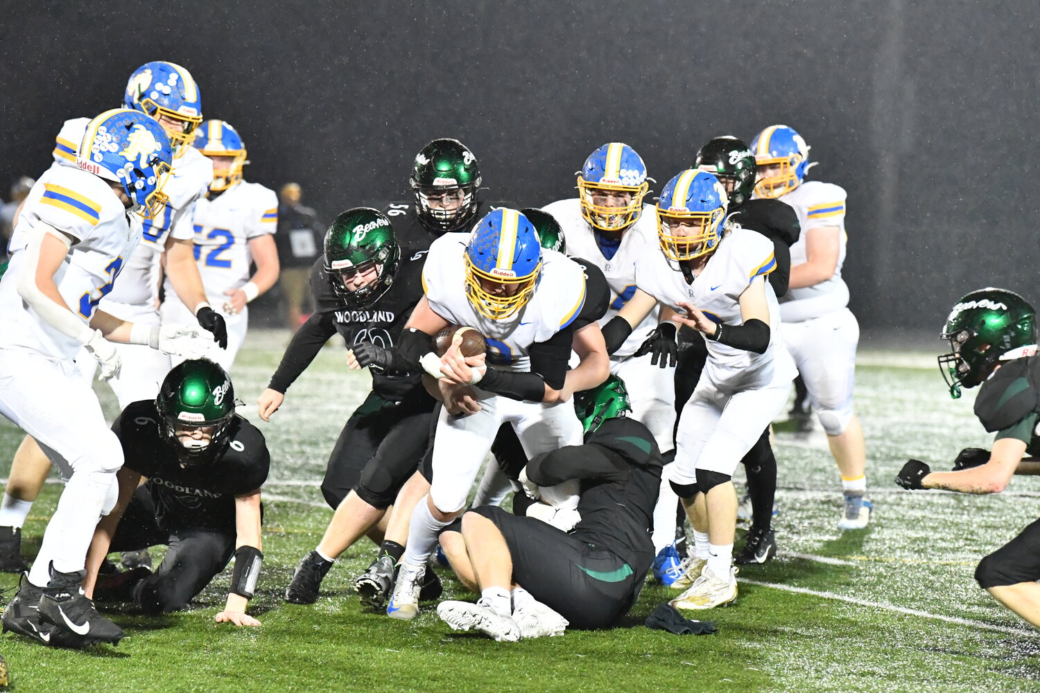 Mason Armstrong can't break free from the Woodland defense in Rochester's 33-8 loss to the Beavers a district crossover game, Nov. 3 in Woodland.